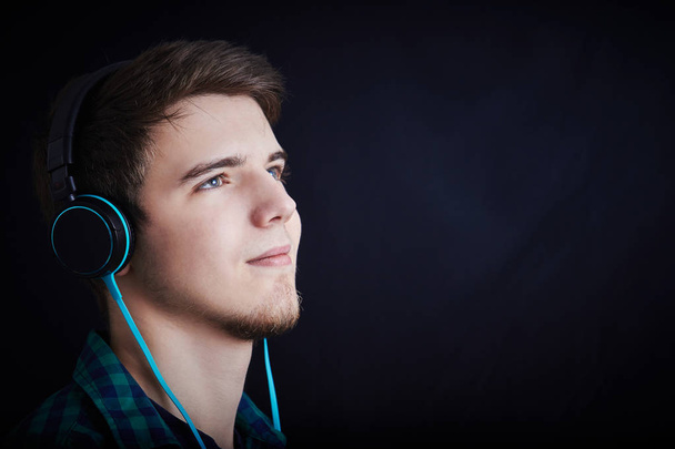 Young man student  listening  to musicand enjoying it. - Foto, imagen