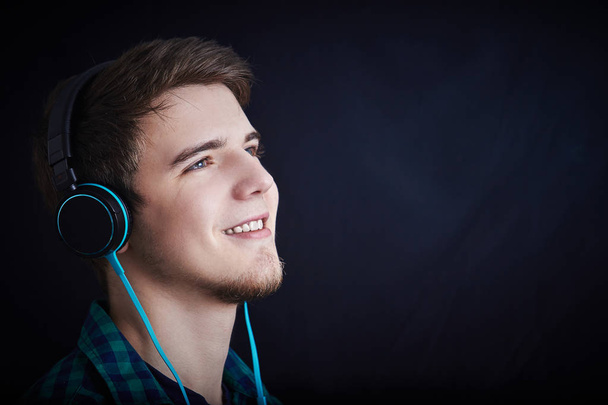 Young man student  listening  to musicand enjoying it. - Фото, изображение
