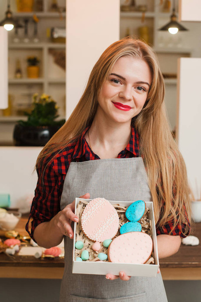 Woman with homemade sweets in kitchen. Cookery. - Фото, зображення