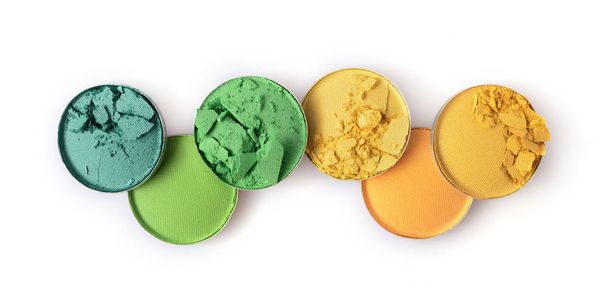 Round yellow and green crashed eyeshadow for makeup as sample of cosmetic product - Zdjęcie, obraz