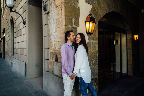  Beautiful couple in love walking streets of the old town - Фото, зображення