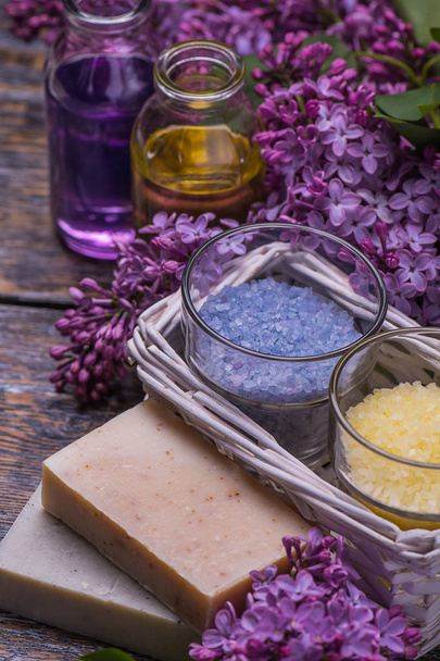Spa setting  therapy with flowers, soap, candles isolated on dark wooden background. Seletive focus - Foto, afbeelding