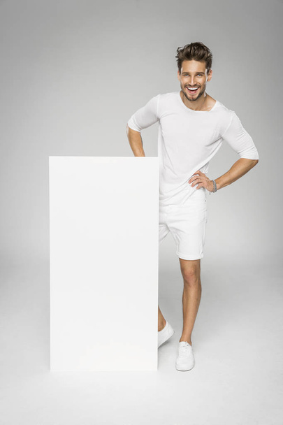 Smiling handsome man showing white empty space - Photo, image