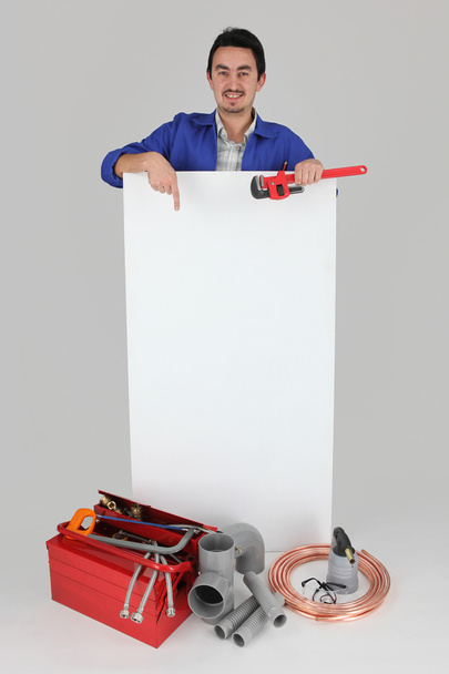 Man pointing at blank board with toolbox - Foto, immagini