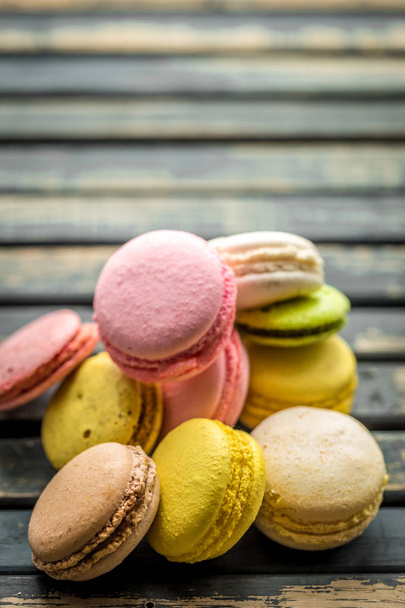 Colorful macaroons on wooden background - 写真・画像