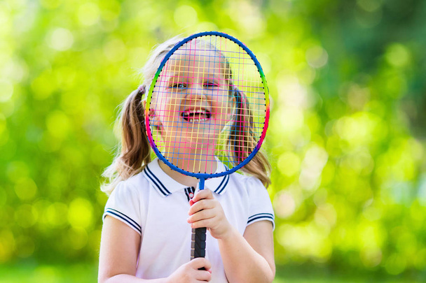 Child playing badminton or tennis outdoor in summer - Photo, image