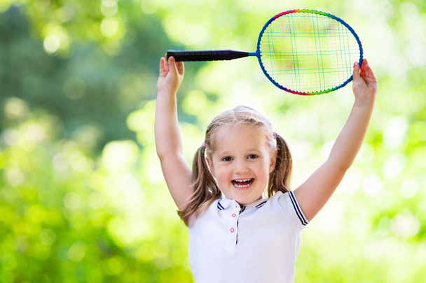 Child playing badminton or tennis outdoor in summer - Fotó, kép