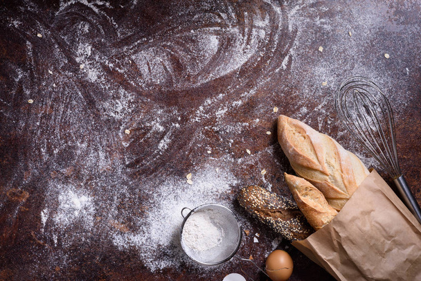 Baking ingredients and baked cookies on rustic background. Flat lay bakery text space images. - Photo, image