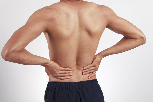 白い背景の上の男性腰痛 - 写真・画像