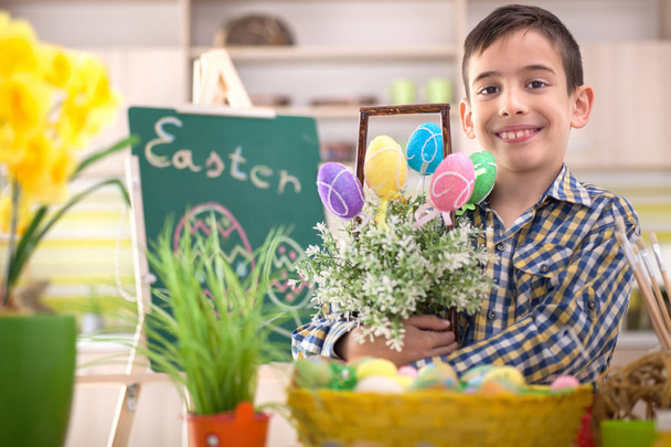 happy smiling young boy holding easter eggs - Фото, изображение