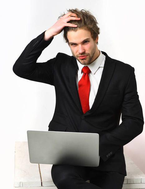 Caucasian stylish business man holding laptop - Fotó, kép
