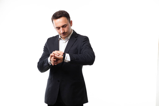 young man in a suit on a white background showing signs - Фото, зображення