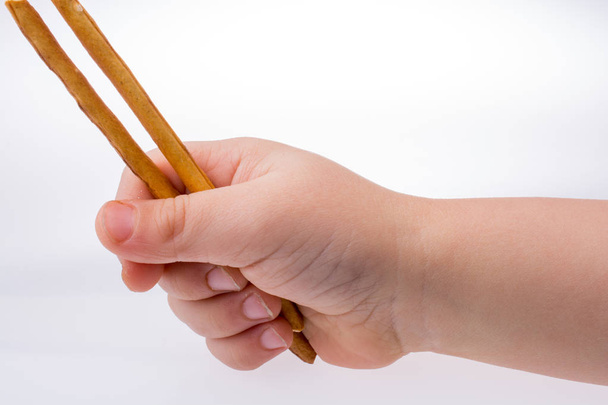 Bambino mano che tiene in mano cracker
 - Foto, immagini