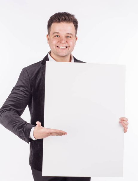 young man holding white blank panel with space for text  - Фото, изображение