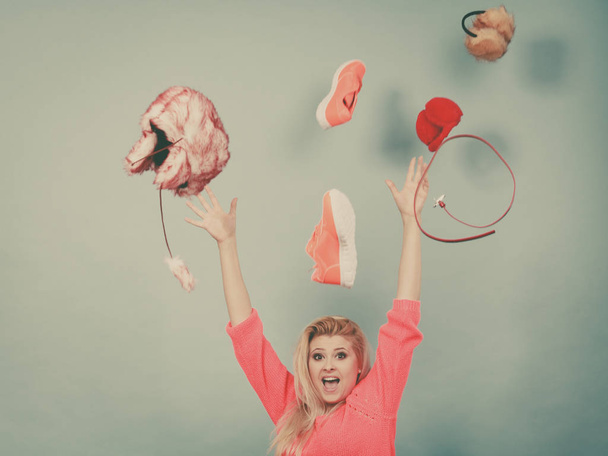 Shocked woman throwing clothes above head - Zdjęcie, obraz