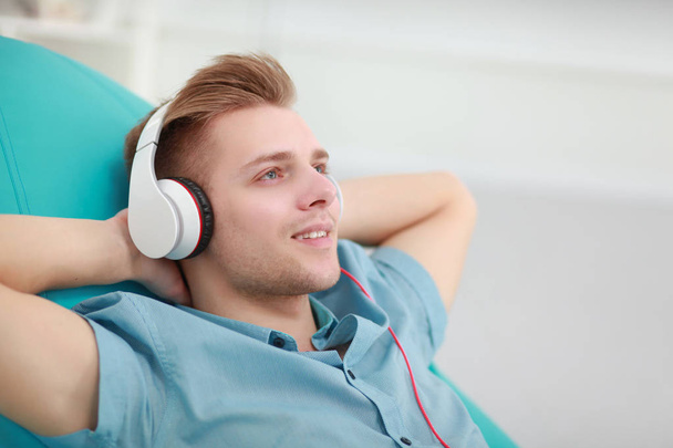 Man listening music with headphones at home - Foto, Imagem