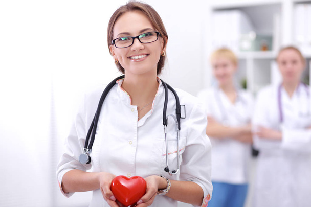 Doctor with stethoscope holding heart, isolated on white background - Photo, image