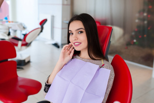Beautiful girl laughs in the dental chair. - 写真・画像