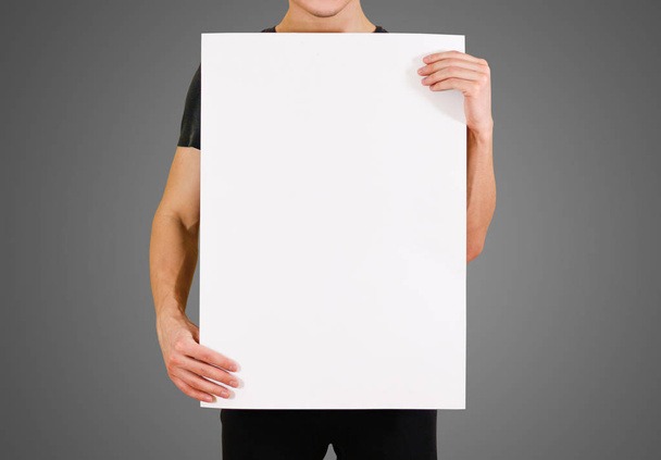 Man showing blank white big A2 paper. Leaflet presentation. Pamp - Foto, afbeelding