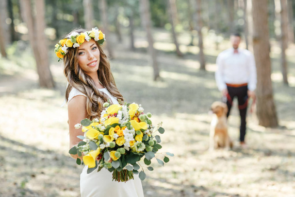  bride with a bouquet in the park - Photo, Image