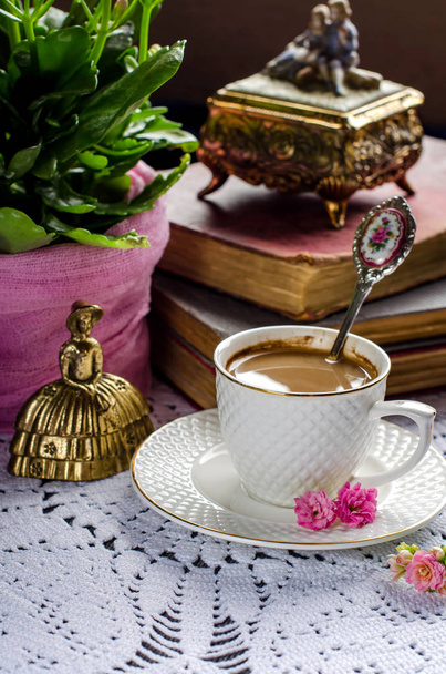 Beautiful vintage still life with flowers, books, a Cup and bell - Photo, Image