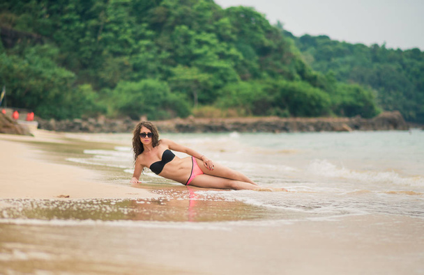 Woman in bikini at tropical beach - Photo, image