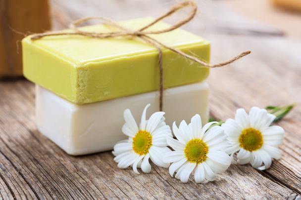 Handmade soap bars and chamomile on wooden background - Photo, Image