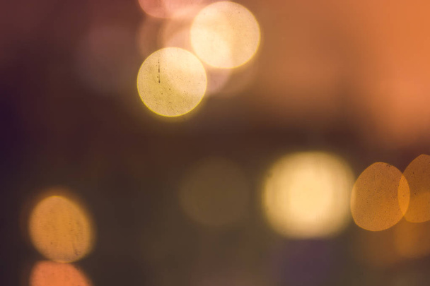 Abstract bokeh blurred background of warm night lights in yellow and orange tone - Photo, Image