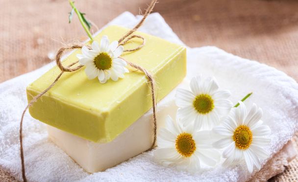Handmade soap bars and chamomile on wooden background - Photo, Image