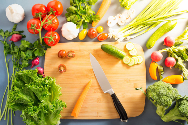 Top view of woman cooking healthy food: cutting vegetable ingred - Fotó, kép