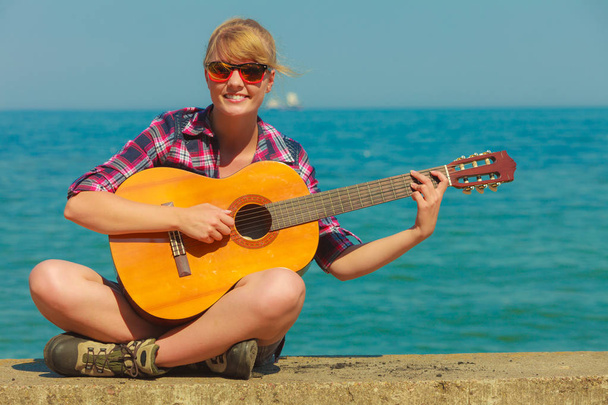 Young woman with guitar outdoor - Fotó, kép