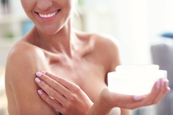 fit woman holding lotion  - Photo, Image