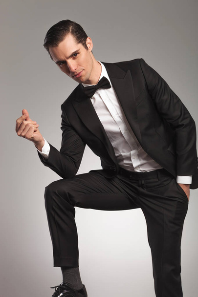 elegant man in tuxedo snapping finger  - Photo, Image
