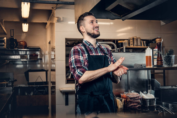 Handsome bearded chef preparing meat - Photo, image