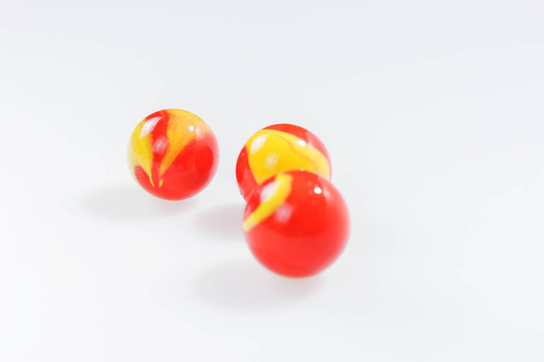 Yellow and Red Marbles on White Background Stock Photo - Image of  difference, game: 66770874
