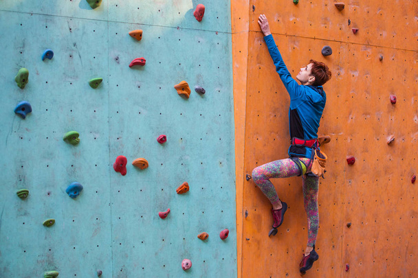 The girl climbs on the climbing wall. - Photo, Image