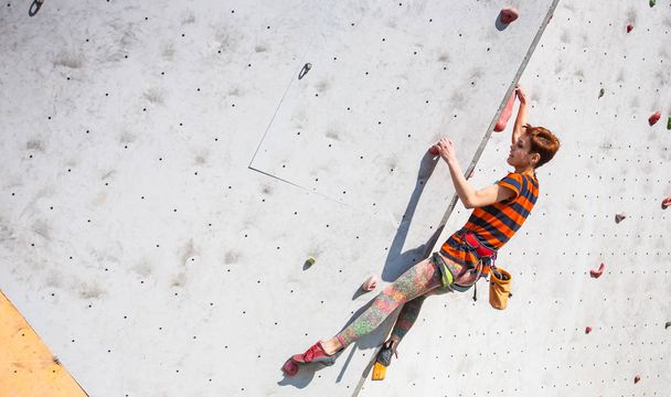 The girl climbs on the climbing wall. - Photo, Image