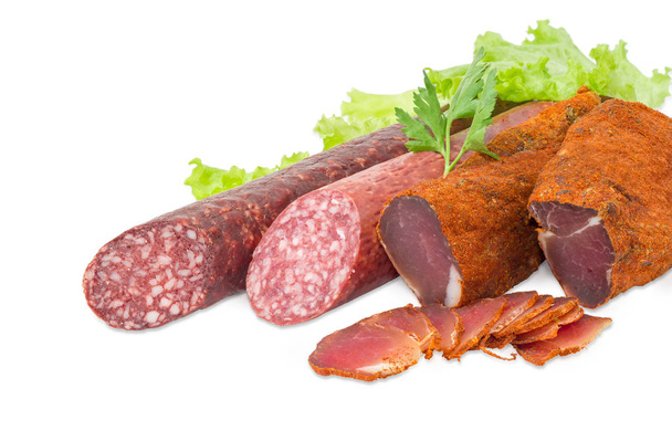 Dried pork tenderloin and two different varieties of sausages closeup - Photo, Image