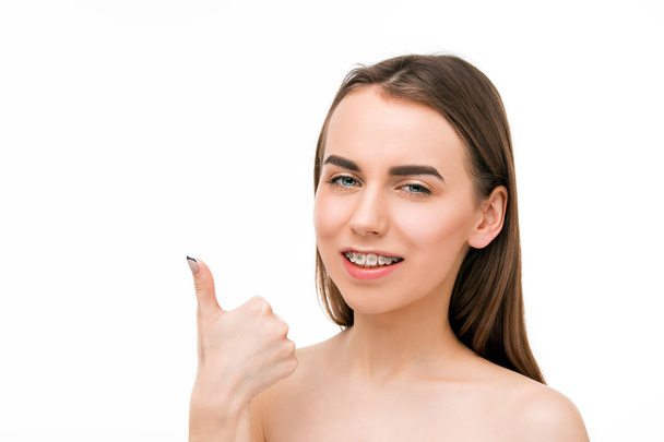 Beautiful young woman with teeth braces - Фото, изображение
