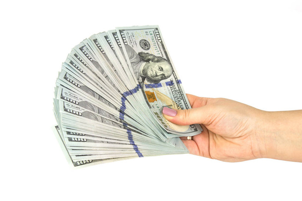 Γυναικείο χέρι κατέχουν πολλά δολάρια τραπεζογραμμάτια σε λευκό φόντο. Κοντινό πλάνο - Φωτογραφία, εικόνα