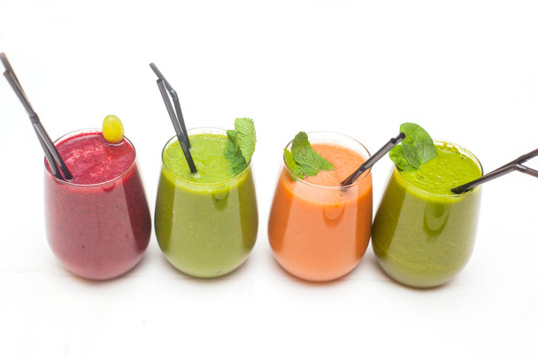Red and green healthy smoothies on table. - Фото, зображення