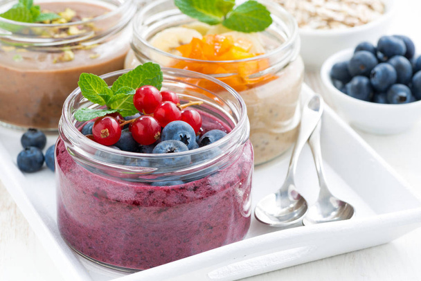 assorted breakfast of chia seeds and fruits in jars, closeup - Fotoğraf, Görsel