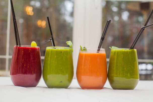 Red and green healthy smoothies on table. - Φωτογραφία, εικόνα