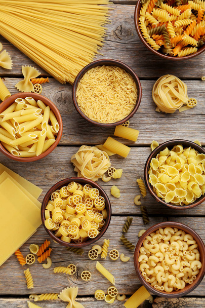 Different kinds of pasta in bowls  - Fotó, kép