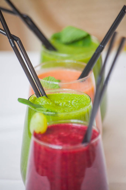 Red and green healthy smoothies on table. - Φωτογραφία, εικόνα