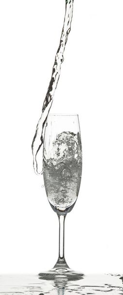 The water splashing to glass on white background - Fotó, kép