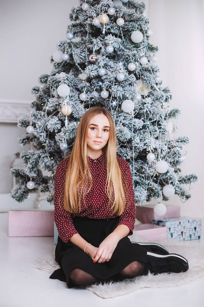 girl sitting near Christmas tree - Photo, Image