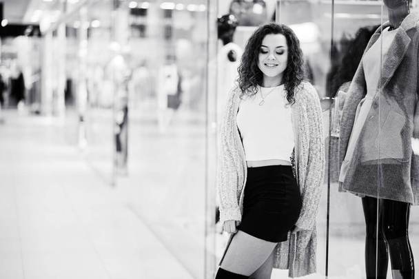 Young curly model girl posed on mini skirt at large shopping cen - Фото, изображение