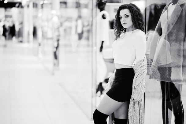 Young curly model girl posed on mini skirt at large shopping cen - Фото, изображение