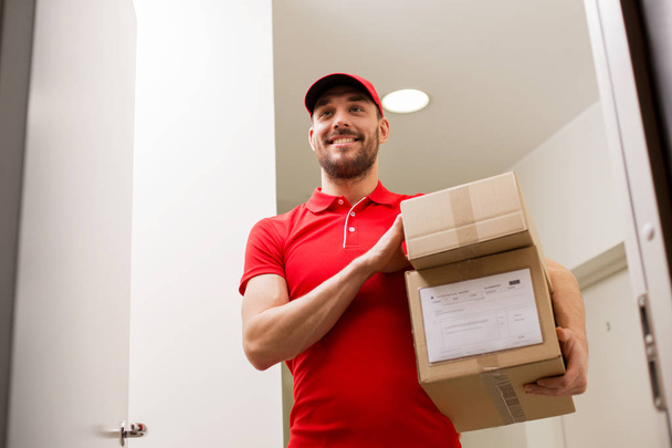delivery man with parcel boxes at customer door - 写真・画像